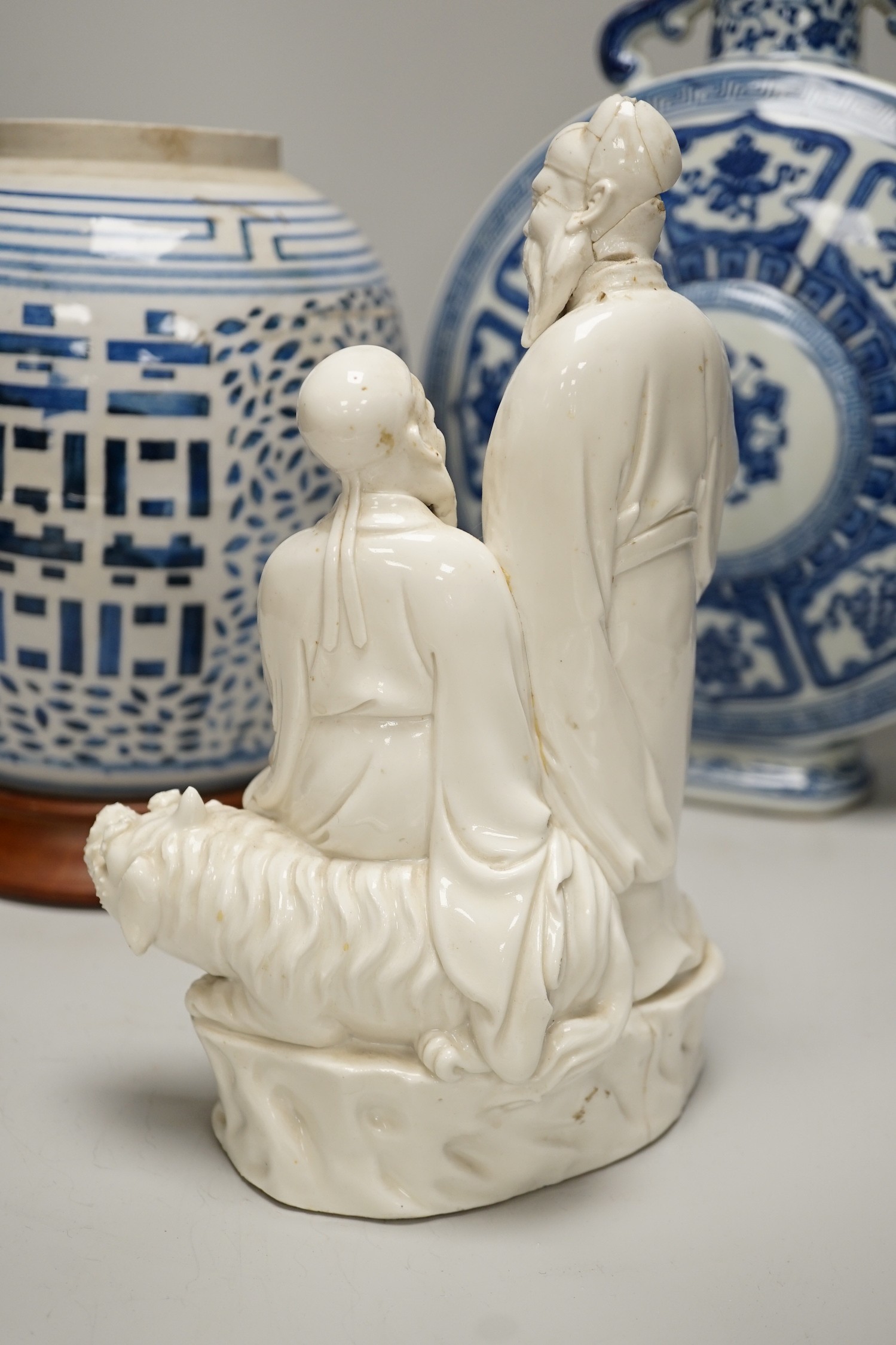 A Chinese blue and white two handled moonflask, together with another Chinese vase and Chinese figure group, tallest 36cm
